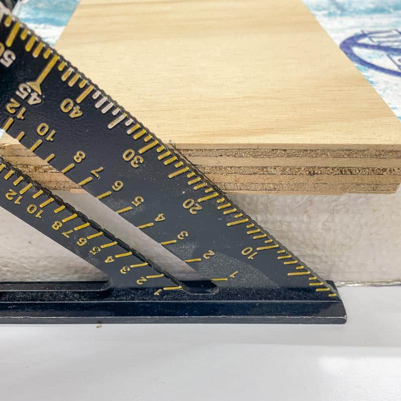 marking angle of French cleat cut on end of board with a speed square