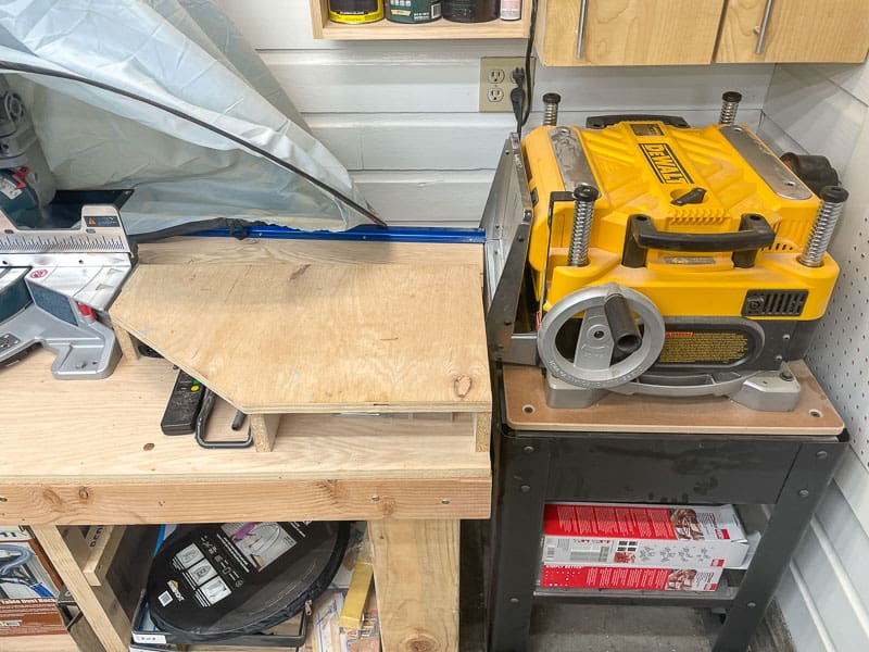 old miter saw station with platforms on sides and thickness planer blocking one end