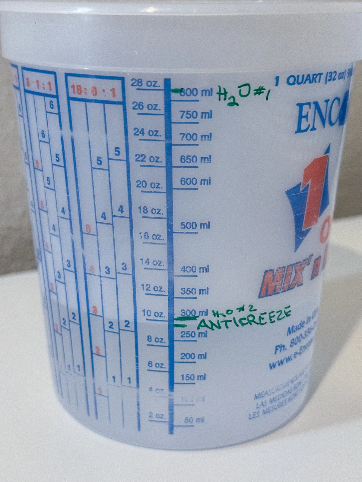 antifreeze and water levels required for a CO2 laser marked on the side of a measuring cup